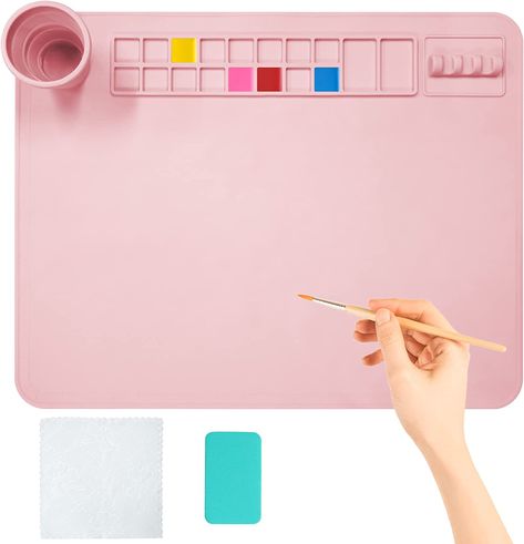 【Product Size】: 20" x 16" inch silicone painting pad, perfect size and thickness, perfect for painting lovers.
【Multifunctional Art Silicone Pad】：The 20"x16" Silicone Art Pad has 16 paint wheels that can hold multiple colors, 2 large central storage slots for mixing various colors, and 4 brush holders on the right side. There is also a collapsible cleaning cup, cleaning towel and cleaning sponge to help you clean quickly, very practical and considerate. Silicone Painting, Paint Brush Cleaner, Silicone Art, Paint Holder, Painting Clay, Cleaning Paint Brushes, Diy Drawing, Gift Painting, Art Mat