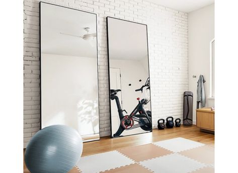 Use large mirrors to create a makeshift home gym, and see other creative ways to use full-length mirrors in your home decor. | 10 Ways to Decorate With Floor Mirrors That Are Right on Trend Home Gym Mirror Ideas, Gym Basement, Home Gym Mirrors, Gym Bar, Workout Room Home, Floor Length Mirror, Gym Mirrors, Basement Gym, Exercise Room