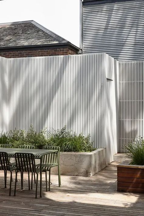 Picture of a tall white fence paired with a concrete raised garden bed with greenery and grasses are a cool idea for a modern space Garden Fence Panels, White Fence, Courtyard Design, The Local Project, Modern Beach House, Hill House, Garden Bed, House Extensions, House On A Hill