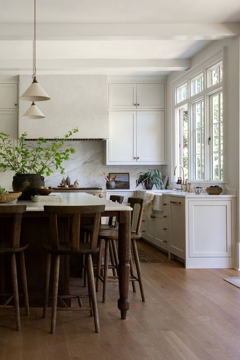 Light filled European inspired kitchen renovation with large kitchen island and pendant lighting in Roswell, Georgia by Prescott Design Dining Table As Island In Kitchen, Table As Island In Kitchen, Large Kitchen Island Styling, Light And Dwell Kitchen, Large Island Decor, Transitional House Decor, Large Kitchen Island Decor, Dark Brown Island, Black Island Kitchen