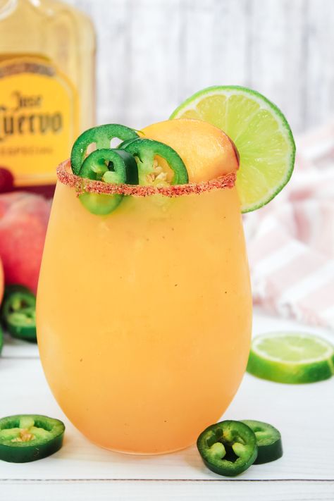 Our Spicy Peach Margarita blends peaches and a hint of spice with tequila, creating a refreshing, adventurous twist on the classic margarita. Spicy Peach Margarita Recipe, Melon Margarita Recipe, Spicy Blackberry Margarita, Peach Margarita Recipes, Blackberry Margarita, Spiced Peaches, Peach Margarita, Margarita Mix, Spicy Margarita