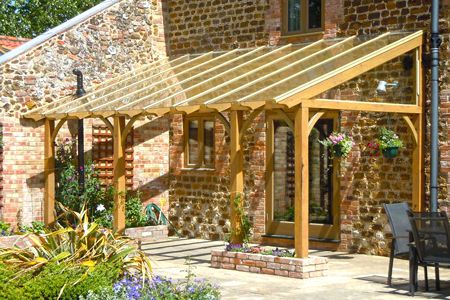 A timber pergola with a glazed roof built as a lean-to on a barn conversion, with small raised brick planters Brick Planter, Timber Pergola, Pergola Diy, Outdoor Sitting Area, Pergola Ideas, Building A Pergola, Pergola Design, Pergola Canopy, Wooden Pergola