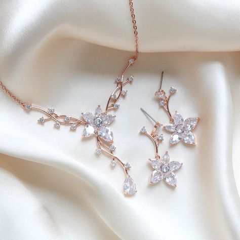 Dainty and elegant Rose gold Bridal jewelry set. Created in a lovely vine floral design that sparkles with Cubic zirconia stones - Necklace measures 16 inches and extends to 18 inches- Earrings dangle 1-3/8"- Rose gold finish- Premium cubic zirconia stones - Nickel free- Available in rose gold, yellow gold and rhodium finish. PLEASE ALLOW APPROX 10 BUSINESS DAYS FOR COMPLETION BEFORE SHIPPING. FOR MATCHING PIECES SIMPLY TYPE "LILY" IN THE SEARCH BAR Simple Rose Gold Jewelry, Elegant Jewelry Gold, Rose Gold Jewellery Aesthetic, Wedding Jewelry Rose Gold, Floral Necklace Jewelry, Rose Gold Bridal Jewelry Set, Rose Gold Necklace Set, Rose Gold Necklaces, Rose Gold Jewelry Set