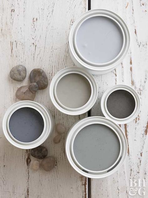 A collection of grays doesn't have to be gloomy. When used correctly, several shades of gray working together make a calm and collected space. Paired with natural elements with warm undertones, such as wood shelving or furniture, gray tones come to life. These gray paint colors include hints of cool blue and beige. Dark Grey Paint, Light Gray Paint, Gallon Of Paint, Popular Paint Colors, Neutral Paint Color, Neutral Paint Colors, Grey Paint Colors, Black And White Tiles, Warm Colour Palette