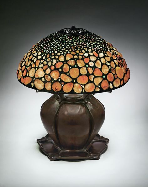 TIFFANY STUDIOS | A Rare ‘Pebble' Table Lamp, circa 1901-1904, constructed with quartz pebbles collected on the shores of Long Island, patinated bronze with a ‘Pepper’ base. 'Pebble' lamps are exceedingly rare, even though the shade was offered in the company’s 1906 price guide for $100 and were in production through at least 1911. This model would have appealed essentially to true connoisseurs, customers with a more sophisticated taste who could better appreciate its subtle beauty and superb cr Orange Ceiling, Pebble Table, Glass Lamp Shades, Stained Glass Lamp Shades, Antique Tiffany, Stained Glass Lamp, Leaded Glass Windows, Tiffany Lamp, 11 December