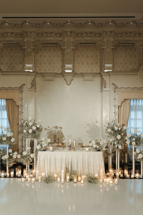 Simplistic romantic sweetheart table inspired by vintage European designs. White Wedding Esthetic, Wedding With Candles And Lights, Elegant Classy Wedding Aesthetic, Vintage Glamour Wedding Decorations, Classic Vintage Wedding Theme, Elegant Classy Wedding Decor, Wedding Head Table Candles, Vintage Old Money Wedding, Ballroom Wedding Decoration