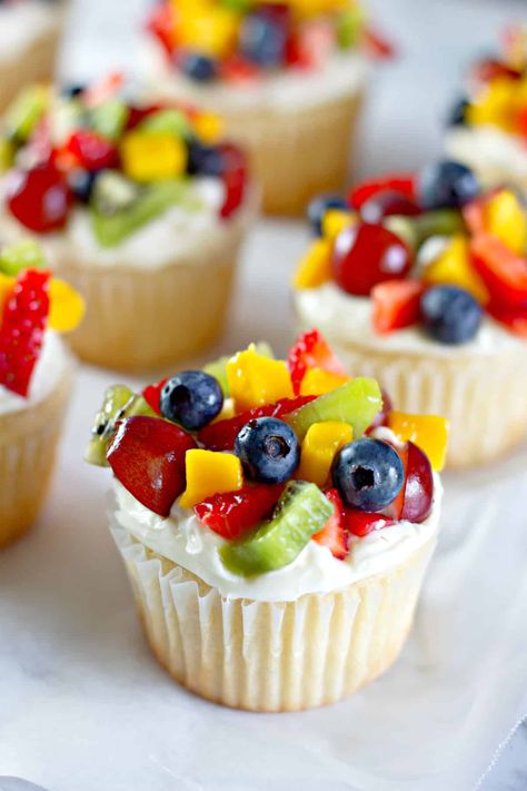 Fruit Pizza Cupcakes are a perfect treat for any occasion! A homemade white cupcake topped with fresh whipped cream cheese frosting and piled high with all your favorite fruits and berries--a really refreshing dessert for any season. #fruit #cupcakes #Cake #fruitpizza #fruitsalad #dessert #dessertrecipes #creamcheese #birthdaycake Fruit Shaped Desserts, Cupcakes Decorated With Fruit, Fresh Fruit Cupcakes, Fruit Cupcake Ideas, Cupcake With Fruit On Top, Fruit Decorated Cupcakes, Fruit Topped Cupcakes, Cupcakes With Fruit On Top, Fruit Themed Cupcakes