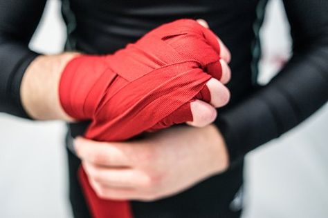 MMA boxing fighter putting hand wraps on hands Hand Wrapping, Wrapped Hands Boxing Aesthetic, Hand Wraps Aesthetic, Hand Wraps, Boxing Wraps, Boxer Workout, Johnson Tsang, Boxing Hand Wraps, Boxing Quotes