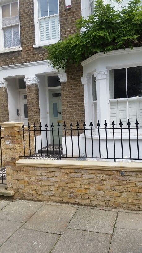 Front garden - brick wall, decorative railing, tiled path and shutter windows Brick Wall With Railings, Front Garden Boundary Ideas, Terrace Boundary Wall Design, Victorian Homes Brick Privacy Wall, Bricks Garden Ideas, Victorian House Fence, Victorian Railings, Victorian Railings Front Gardens, Edwardian Railings