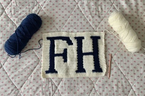 A crochet panel (sample swatch, pattern test) based on a useful pixel grid pattern of Conan Gray's iconic FH symbol from his 3rd studio album "Found Heaven." The pattern contains the letters F and H from his knit sweater in navy blue and an ivory white background. Great inspiration and guide for crochet and knit projects surrounding this musical album and its songs/concepts. Conan Gray Crochet, Found Heaven, Crochet Hdc, Pixel Grid, Gray Knit Sweater, Gray Crochet, Free Pattern Crochet, Knit Projects, Crochet Inspo