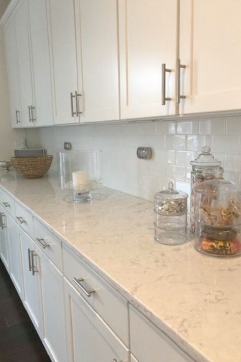 White kitchen with Viatera Minuet quartz countertops - Hello Lovely Studio. White Kitchen Cabinets With Beige Quartz, White Cabinets With White Quartz Counter, White Counter Tops With White Cabinets, Kitchen Countertops With White Cabinets Quartz Carrara Marble, Quartz Counter Tops With White Cabinets, White Counter And Backsplash, White Kitchen Counters Quartz, Ventina Quartz Countertops, Viatera Karis Quartz Countertops