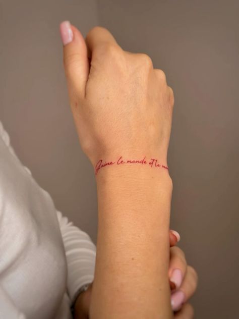 Wrap Around Quote Tattoo, Finger Tattoos Red Ink, Forearm Bracelet Tattoo Women, Red Ink Wrist Tattoo, Con Amor Tattoo, Red Tattoo Hand, Amor Tattoos For Women, Fine Line Red Tattoo, Tattoo On Wrist For Women