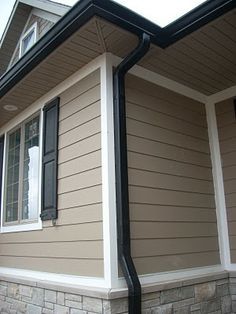 Black Gutters. windows are white vinyl with black trim and exterior is blue/grey.. I think its gonna look gooood Black Gutters, Roof Soffits, Retirement Goals, Tan House, Shop Exterior, House Upgrades, Roof Ideas, Black Shutters, Housing Ideas