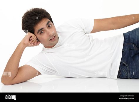 Download this stock image: Young man lying on side on the floor - WP9BNX from Alamy's library of millions of high resolution stock photos, illustrations and vectors. Man Slouching Pose, Guy Laying Down, Lying On Side Pose Reference, Lying On The Floor Reference, Lying Pose Drawing, Person Lying On The Floor, Lie Down Pose, Laying On Side Pose, Laying On Side Pose Reference