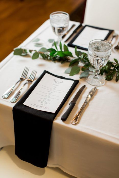 a chic yet simple black and white wedding tablescape with a greenery runner, black napkins and white menus White Wedding Table Setting, Gold Winter Wedding, Wedding Table Menus, Winter Wedding Table, Wedding Candles Table, Abby Anderson, Black And White Wedding Theme, Black Napkins, Elegant Winter Wedding