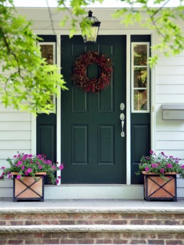 A hunter green door buoyed by clean, white trim will never go out of style. See more colorful doors >> Front Door Landscaping, Green Front Door, Front Door Planters, Door Planter, Green Front Doors, Beautiful Front Doors, Black Shutters, Front Door Paint Colors, Custom House Numbers