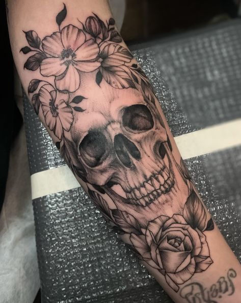 Skull Flowers Tattoo, Skull And Flower Tattoo Forearm, Realistic Skull Tattoo Design, Half Skull Half Face Tattoo, Flower With Skull Center Tattoo, Skull Made Out Of Flowers Tattoo, Flowers Coming Out Of Skull Tattoo, Skull Flower Arm Sleeve, Pretty Skull Tattoos