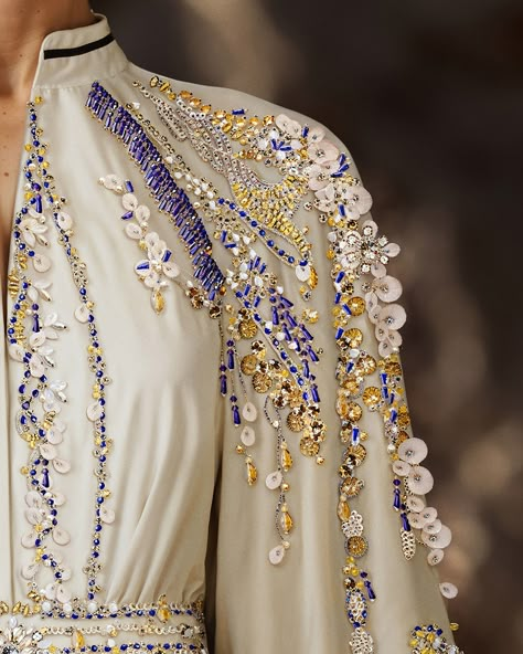 Unveiling the off-white crepe kaftan, paired with a beaded taffeta cape. Embroidery cascades gently from shoulders to skirt, showcasing the impeccable craftsmanship.​ #SaiidKobeisy​​ #Kaftan​ #HauteCouture Cape Embroidery, Embroidery Kaftan, Beading Design, Saiid Kobeisy, Eid Outfits, Tambour Embroidery, Hand Embroidery Kit, Dress Inspiration, Islamic Fashion