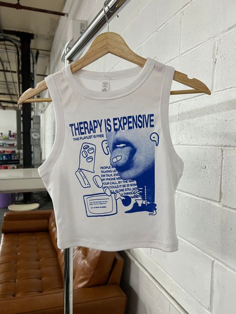 Music Medicine Tee/Tank. Original design: Therapy is expensive, this playlist is free. Check out my shop for more pop culture or music-inspired items! Shirt material is 50/50 cotton and polyester. Blue ink on White Clothing Each item is uniquely hand screen printed and designed by me! Available on: White Cropped Tank, Women's Sizing: XS, S, M, L, XL, XXL --Fitted, cropped, can fit for men's sizing, size up/refer to size chart White T-Shirt, Unisex Sizing: S, M, L, XL -- Regular fit, lightweight Music Tshirt, Screen Print Shirt, Cool Merch, Cool Merch Ideas, Screen Printing Clothes, Pattern Texture, White Crop Tank, Screen Printing Shirts, Blue Tee