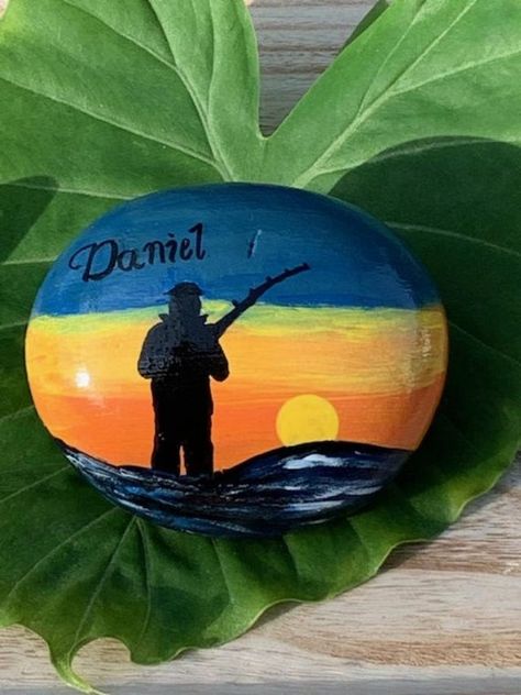 Fishing SihouetteCustom Natural RockHome Decor | Etsy Fishing Painting Ideas, Fishing Rock Art, Nature Painted Rocks, Fishing Rock Painting, Gone Fishing Rock Painting, Fishing Rock Painting Ideas, Hunting Rock Painting, Fishing Painted Rocks, Rock Home Decor