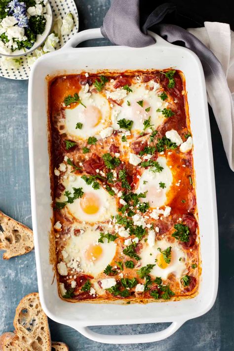 For a simple twist on this traditional Middle Eastern Breakfast, try our easy oven baked shakshuka! It is perfect for your next brunch. Baked Shakshuka Recipe, Shakshuka In Oven, Shakshuka For A Crowd, Sheet Pan Shakshuka, Oven Baked Shakshuka, Easy Dinner Recipes Oven Bake, Feta Breakfast Recipe, Oven Shakshuka, Shakshuka Recipe Traditional