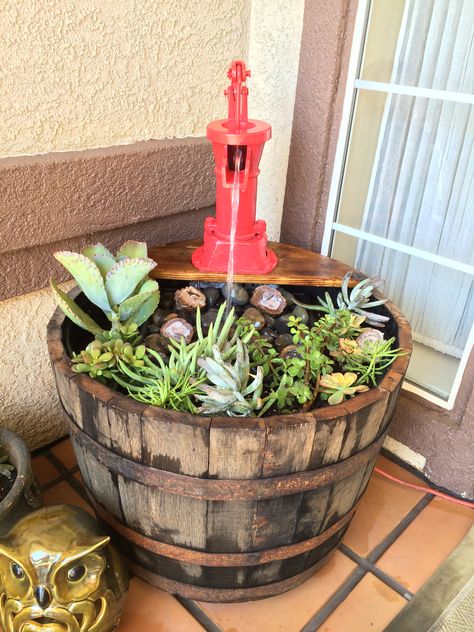 Whiskey barrel planter and fountain. Barrel Garden Ideas, Barrel Planter Ideas, Whiskey Barrel Flowers, Barrel Garden Planters, Wine Barrel Garden, Fountain Planter, Barrel Fountain, Barrel Flowers, Whiskey Barrel Planter