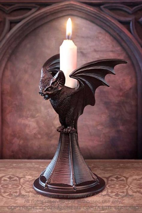 This beautifully sculpted Bat candle stick is hand finished in the finest quality black resin. A dark and dramatic candle stick to bestow your dining table, boudoir or altar. Silent sentinel delighting in night. Flying on the border between one world and the next. Be it bird or beast at dusk or dawn, forever unseen at the dark of the moon. Candle stick not included, but you can purchase candles separately. Weight & Dimensions (approx.):H: 18.2cm (7.17") W: 11.8cm (4.65") D: 11.5cm (4.53") Weight Halloween Candlesticks, Gothic Candle Holder, Gothic Candle, Night Flying, Gothic Candles, Alchemy Gothic, Halloween Room Decor, Halloween Gothic, Goth Decor