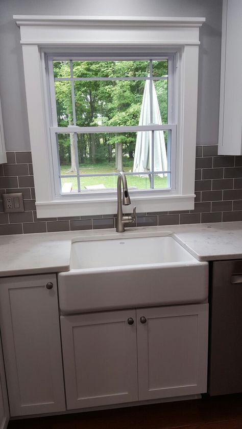 Cloud grey glass subway tile around window. Faucet is by Moen. White Subway Tile Kitchen Backsplash Around Window, Subway Tile Kitchen Window, Backsplash Ideas Around Kitchen Window, Kitchen Sink Backsplash With Window, Subway Tile Around Window, Kitchen Backsplash Around Window, Backsplash Around Window, Tile Around Window, Rustic Kitchen Sinks