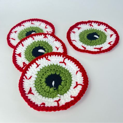 Spooky Set Of 4 Handcrafted Crochet Halloween Eyeball Coasters Handmade By Me Get Ready To Spook Up Your Halloween Decor With This Handcrafted Crochet Eyeball Coaster! Perfect For Adding A Creepy Yet Fun Touch To Your Party Or Coffee Table. Made With Love And Attention To Detail, This One-Of-A-Kind Coaster Is Sure To Be A Conversation Starter At Your Halloween Gatherings. Grab It Now To Add A Ghoulishly Delightful Twist To Your Home! 100% Acrylic Yarn Measurements Approximately 4 1/2” Halloween Handmade Halloween Gifts, Small Practical Crochet Projects, Crocheted Halloween Decorations, Crochet Patterns Halloween Free, Eyeball Halloween Decor, Crochet Halloween Ornaments, Halloween Crochet Coasters, Halloween Crochet Decor, Red Halloween Decor