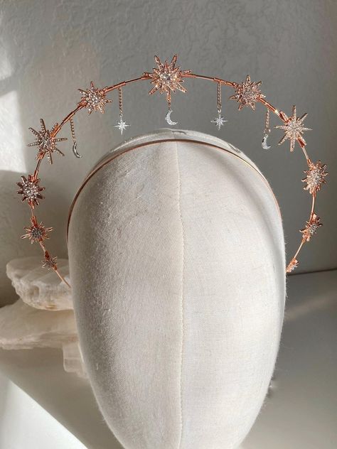 Handmade and one of a kind, this stunning golden halo is the perfect crown to finish off any look. Perfect for the bohemian, dreamy bride, this crown sits comfortably on the head and makes you shine without getting in the way. Stunning starburst embellishments in rose gold, with silver northern polaris stars and crescent moons dangling and swaying with your movements. The mixture of metals give a rich and unique look to truly make you stand out. They rest on a stunning rose gold halo, this headp Wedding Halo Crown, Celestial Wedding Jewelry With Halo, Star Wedding Halo, Halo Crown Headpieces, Celestial Bride Crown, Moon Halo Crown, Crown Of Stars, Star Halo Crown, Celestial Halo Crown