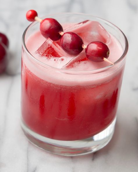 Recipe: Cran-Cherry Whiskey Sour | festive drinks, holiday party menu, holiday cocktails, cranberry cocktails, winter drinks, whiskey sour ideas Cranberry Cocktails, Fig Wine, Cherry Whiskey, Holiday Party Menu, Cranberry Drinks, Spicy Candy, Cranberry Cocktail, Vanilla Milkshake, Frozen Cranberries