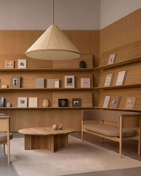 In Copenhagen's historic Ny Østergade, @new_mags has unveiled its flagship store, a quiet oasis designed by @normarchitects , showcasing a curated selection of lifestyle books, collectibles, and magazines. Inspired by the classic library, the design showcases these books as pieces of art, surrounded by carefully selected sculptures and objects. The use of natural materials like oak wood and golden sandstone creates a calm and gentle backdrop, encouraging visitors to delve into the diverse se... Long Study Table, Lifestyle Books, Library Interior, Space Icons, Dragon House, Norm Architects, Store Design Interior, Store Interior, Office Interior