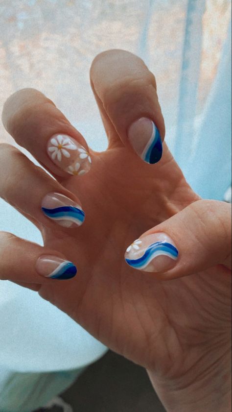 Retro 70s blue wave & flower nail art, acrylic nails, clear base, dark - medium - blue lines & white line on all fingers except middle, middle finger with retro white flowers

Nail art done by Rino Nail Bar in Denver, CO Blue Themed Acrylic Nails, Flower And Squiggle Nails, Wave Nail Art Simple, White 70s Nails, Retro Wave Nails, Blue Groovy Nails, 70s Nails Retro Blue, Blue 70s Nails, Blue Waves Nails