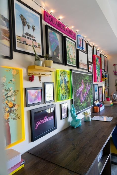 Maximalism at its finest. This gallery wall features bright and fun artwork that is framed with neon acrylic frames with solid black mixed in, creating a fun and creative wall. Colorful Art Gallery Wall, Vintage Living Room Wall Color, Maximalist Makeup Room, Modern Maximalist Decor Office, Diy Maximalist Wall Art, Random Gallery Wall, Maximalist Photo Wall, Colorful Gallery Wall Living Room, Neon Gallery Wall