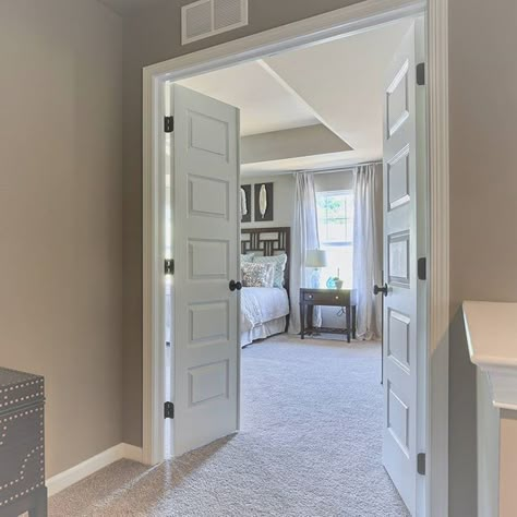 The double door entry to the master bedroom in our Bristol model on Archer Lane in Columbia, PA in the Sylvan View community. Paint color is Sherwin Williams Morris Room Grey (SW0037) in flat finish. Click here to see more interesting entryway design photos! Double Bedroom Doors Entrance, Master Room Double Doors, Double Door Room Ideas, Double Doors For Bedroom, Double Door Interior Bedroom, Large Bedroom Door, Double Door For Bedroom, Primary Bedroom Double Doors, Oversized Bedroom Door