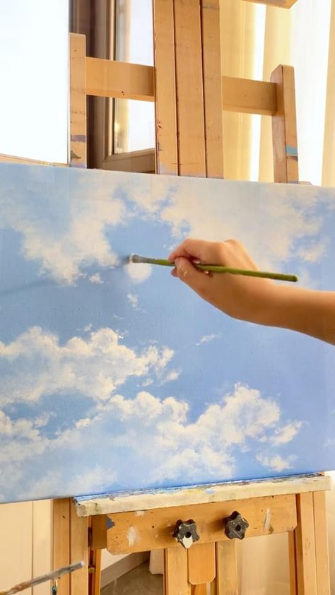 When I painted this painting, I want to show the harmonious beauty of the blue sky and the cloud. I used a light blue base colour to depict the blue sky, while the clouds were painted with white and grey paint. I used different brush atroked and colours in order to recreate the clouds innature as much as possible and to make them look more realistic. Clouds With Watercolor, How To Paint Clouds, Canvas Art Painting Abstract, Painting Sky, Sky Art Painting, Canvas Painting Tutorials, Grey Paint, The Blue Sky, Landscape Art Painting