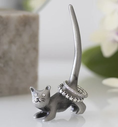 Metal Cat Ring Holder 🐈 £13.50 Free Postage ❤️ Keep rings tidy with this sweet ring holder shaped like a cat. Made of iron and makes an adorable decor piece on a vanity or dressing table. H9cm x W5cm x D2cm Elephant Ring Holder, Cat Ring Holder, Unusual Clocks, Metal Cat, Sweet Ring, Iron Ring, Cat Ring, Animal Rings, Like A Cat