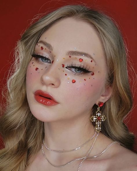 Valentines Makeup With Gems, Heart Tears Makeup, Heart Festival Outfit, Heart Gems On Face, Eye Makeup With Hearts, Red Jewels Makeup, Cupid Inspired Makeup, Red Gemstone Makeup, Heart Glitter Makeup