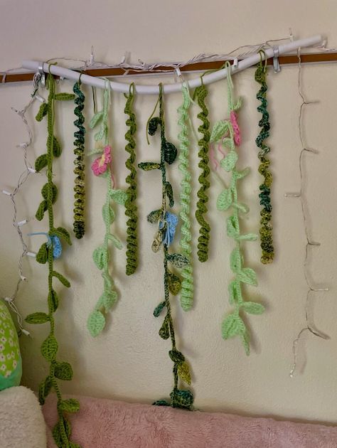 I made these vines with flowers for my daughters dorm room and love how they turned out! Can be made bigger or smaller if needed. Different color flowers can be made as well. Does not include the foam bar the vines are tied on. I NO LONGER HAVE THE MINT GREEN COLOR YARN. I HAVE BEEN USING GRASS GREEN INSTEAD AND IT LOOKS GORGEOUS Crochet Room Decor Wall Hangings, Crochet Hanging Vines, Crochet Vines, Vines With Flowers, Flower Room Decor, Crochet Hanging, Fairy Lights Bedroom, Lights Bedroom, Hanging Vines