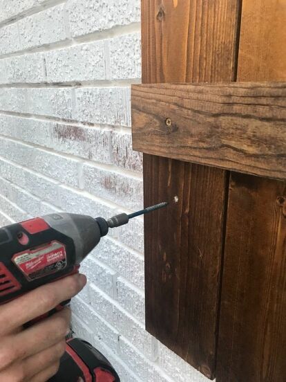 My husband and I looked for different ways to hang our DIY wood shutters onto our brick house, and there were quite a few different options that we came across. It got slightly confusing, so I thought I’d share what we decided to do and what worked for us.I’d like to note that we are not pros, but this is what we found to work for us. We started by holding the shutter up where we were planning to hang it on the house. From there, we marked the shutter where the mortar line on the hou… Diy Shutters Exterior Brick Homes, How To Hang Shutters On Brick, Wooden Shutters On Brick House, How To Make Shutters, Wood Shutters On Brick House, Shutters Brick House, Diy Wood Shutters, Shutters Diy, Wood Shutters Exterior