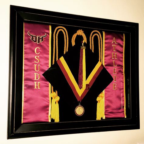 Pin your graduation cap, sash, tassel, cords, and medals to preserve them and display them. This beats using them once and storing them away in the closet to be forgotten. Use a shadow box about 16x18" with a foam backboard that will easily hold the pins. This shadow box was found at Michaels. Diploma Shadow Box Ideas, Diploma Display Wall, Tassel Ideas, Graduation Regalia, Graduation Cords, Diploma Display, Graduation Display, Shadow Box Graduation, Grad Stoles