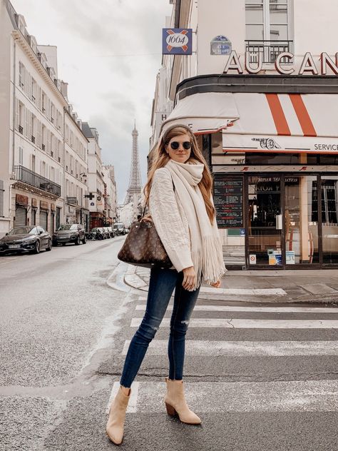 Lifestyle blogger shares what to wear in Paris in October | Lifestyle blogger shares what to wear in Paris in October | What to Pack for Paris in October by popular London travel blogger Mollie Moore: image of a woman standing outside in Paris and wearing a Zara CABLE-KNIT SWEATER, Free People FREE PEOPLE Whisper Fringe Blanket Scarf, Main, color, BLACK Whisper Fringe Blanket Scarf, Nordstrom Mother The Looker High Waist Frayed Ankle Skinny Jeans, J.Crew Western boots in tan suede, Asos River I Europe Fashion October, London Outfits For October, Paris Outfits For October, What To Wear In Paris In October 2023, Europe Travel Outfits October, Fall Paris Fashion, Switzerland In October Outfits, What To Wear In Amsterdam In October, What To Wear In Switzerland In October