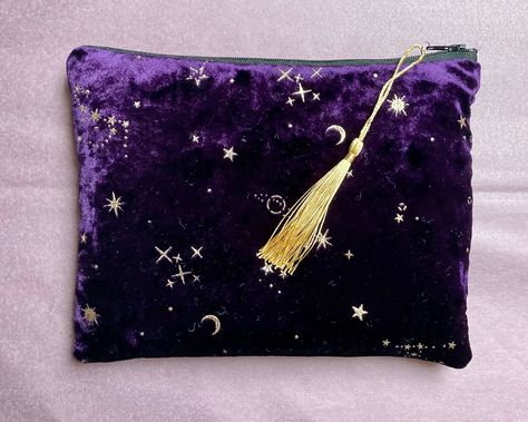 Purple Crushed Velvet Make Up Bag / Pouch / Purse This is a beautiful to touch silky velvet slouchy bag with gold stars, moon and sun embellished details.  The bag is lightly padded and fully lined with 100% cotton black fabric.  There is a contrasting black fabric zip.  It is perfect for holding cosmetics or to be used as a purse or clutch. Measures approx 8 inches wide and 6 inches deep. Pattern placement may vary slightly as each bag is individually handmade by me in the UK. Bee Makeup, Velvet Purple, Sparkly Outfits, Black Clutch Bags, Velvet Purse, Slouchy Bag, Velvet Clutch, Pouch Purse, Stars Moon