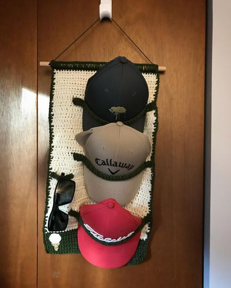 Wall hanging hat and sunglasses holder for my dad’s Father’s Day gift. He is an avid golfer and man with many hats. Peep the golf ball and tee in the left corner (yes it does also look like an ice cream cone haha) 🧢⛳️ • • • • #golf #fathersday #gift #dad #father #crochet #hat #hats #hatholder #golfhats #sunglasses #lifestyle #homedecor #organization #homeorganization Crochet Golf Accessories, Golf Crochet Patterns, Grandpa Crochet Gifts, Crochet Gift For Husband, Crochet Golf Ball, Crochet Christmas Gifts For Men, Crochet Hat Holder Pattern, Crochet Mens Gifts, Crochet Gift Ideas For Guys