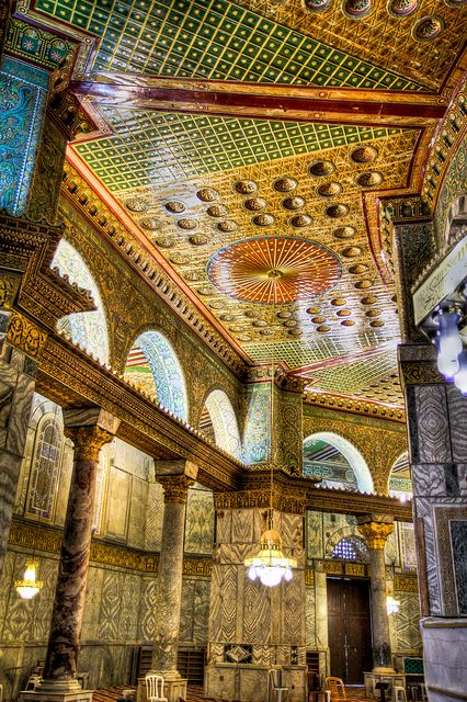 Fig. 10 Interior with inscriptions, The Dome of Rock inside.  The walls are covered in marble with mosaics in which thousands of small cubes of coloured and gilded glass and stone. A narrow band of inscriptions in Arabic written in gold on a blue ground and quoting passages from the Koran. Writings from caliph Abd al-Malik who created the New System of writing in Arabic. pg 29 Rock Interior, The Dome Of The Rock, Al Quds, Dome Of The Rock, Beautiful Mosques, The Holy Land, Sacred Places, Islamic World, Place Of Worship