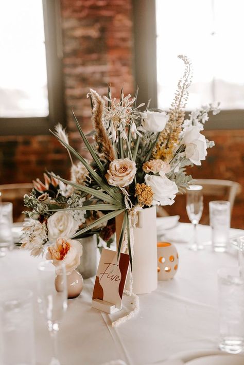 Whimsical industrial meets modern elegance Tampa Heights wedding at Armature Works with brick walls, greenery inspired centerpieces and long wooden tables. Boho Wedding Vases Centerpieces, White Vase Wedding Centerpiece, Boho Vase Centerpieces, Coastal Boho Wedding Decor, Small Boho Centerpieces Wedding, Whimsical Table Decor, Small Boho Centerpieces, Coastal Boho Wedding, Small Centerpieces Wedding