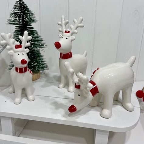 Who won't fall in love with our cute family of Standing Ceramic Reindeer In Striped Scarves Each of our lovely reindeer are made in ceramic with a white shiny glaze, each wearing a lovely red scarf and red and white hat with a bright red shiny nose Choice of three sizes and designsSmall standing deer measures 10cms long x 12.5cms high x 5cms wideLarge standing deer measures 12.5cms long x 15.5cms high x 5.5cms wideLarge feeding deer measures 13.5cms long x 9.5cms high x 6.5cms wide They are all looking for a new home this Christmas time sitting in your home amongst your festive decorations! Ceramic Reindeer, Red Scarf, Striped Scarves, Red Scarves, White Hat, Cute Family, Tealight Candle Holders, Tea Light Candles, Christmas Table