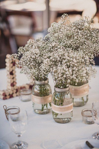 Baby’s breath has a gentle country charm. Place them in mason jars wrapped in ribbon and burlap for full effect. Amazing Wedding Centerpieces, Rustic Wedding Details, Wedding Centerpieces Mason Jars, Cheap Wedding Decorations, Rustic Wedding Decorations, Breath Flowers, Country Wedding Decorations, Rustic Wedding Table, Mason Jar Wedding