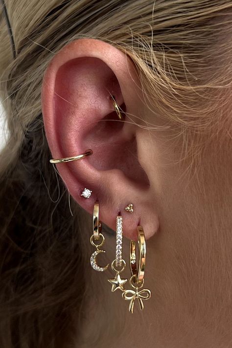 Customize your stack with a few versatile (and adorable) earring charms Earring Pairings, Staggered Ear Piercings, Stack Ear Piercings, 3 Hole Earring Stack, Stacked Love Ear Piercings, Ear Lobe Stack, Piercing Inspiration, Earring Stack Ideas, Ear Piercing Ideas