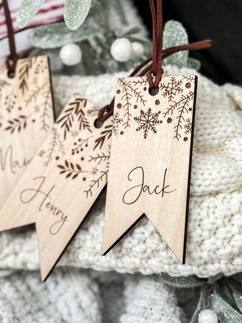 These laser cut and engraved custom wood stocking tags will add a beautiful and personal touch to your Christmas decor that can be used year after year! Each tag comes with a premium suede cord to easily attach the to your stockings. Each tag is made from 1/4 inch birch. Christmas Wood Engraving Ideas, Cricut Wood Engraving Projects, Laser Wood Christmas Ideas, Holiday Laser Projects, Laser Engraved Wood Projects, Wood Stocking Tags, Wood Engraved Ornaments, Wood Laser Ideas Products, Name Tags For Stockings Diy